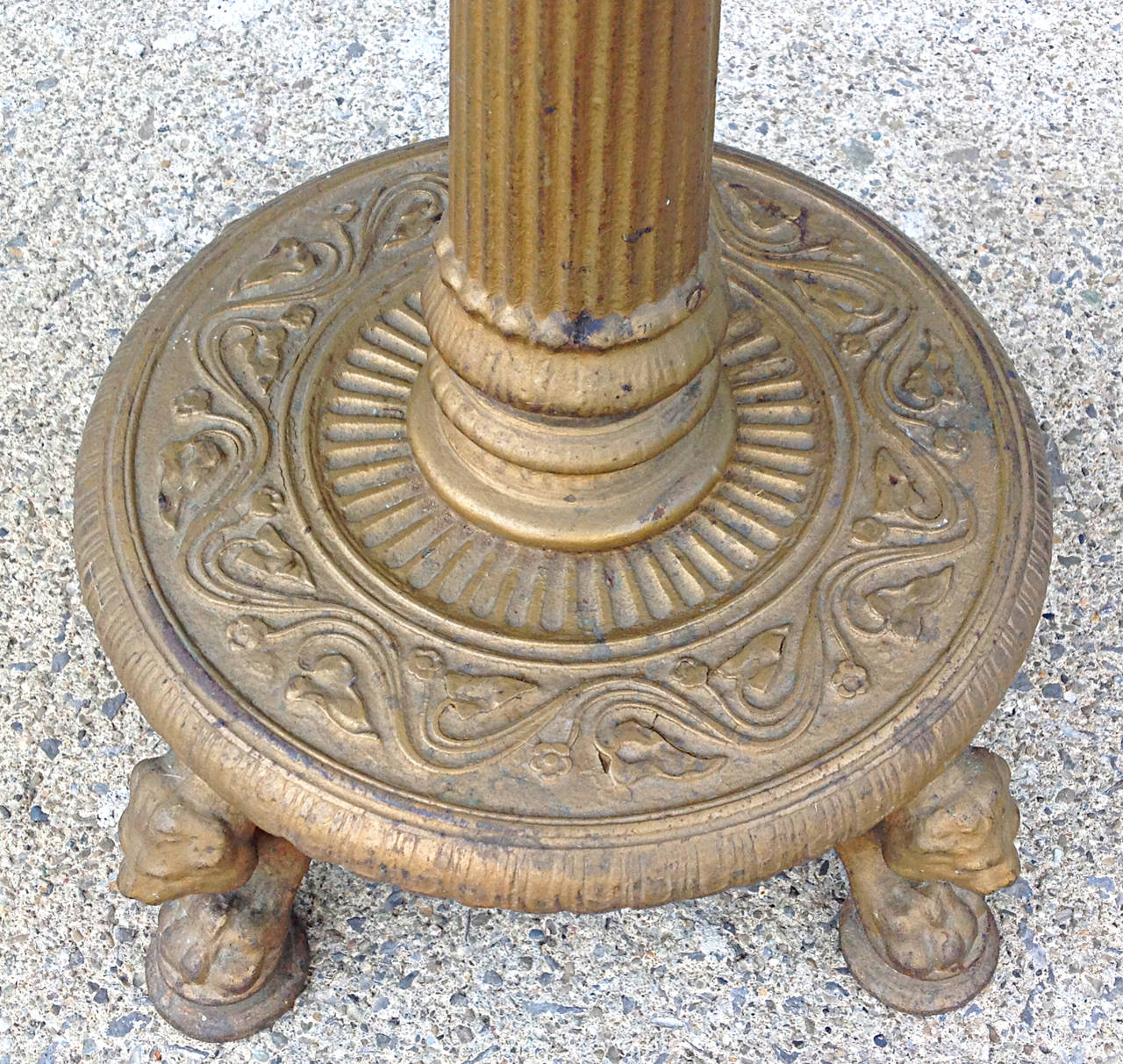 Late 19th century polychromed iron pedestal with paw feet, lion and dog heads. Intricate detail in casting.