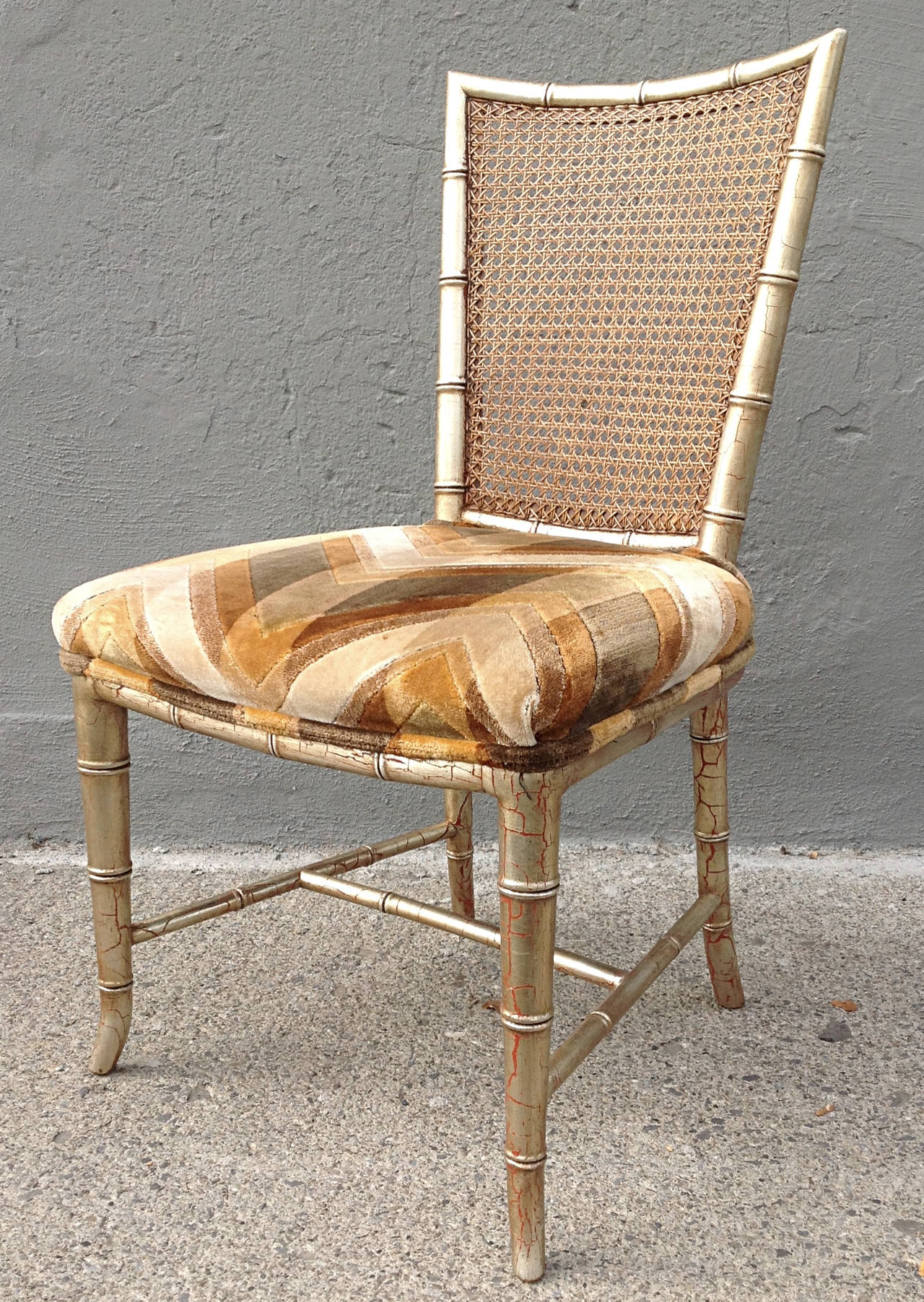 Set of six dining chairs by Karges circa 1970. Silver over coral crackle finish. Faux bamboo wood frame with caned backs. Original cut velvet modern flame stitch in burnt earth tones. Frames in excellent condition, upholstery is serviceable fine but