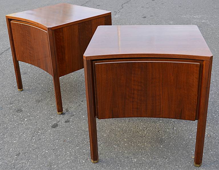 An elegant pair of matching end tables by Edmond Spence. Walnut construction with a concave curved front single door and hexagonal legs with brass sabots.
Long dresser and gentleman's chest available as well.