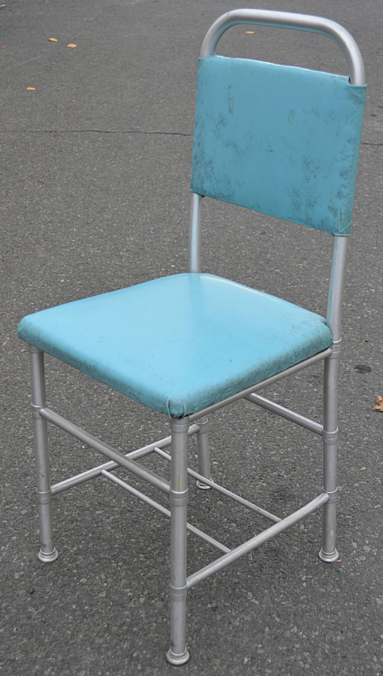 Classic Warren McArthur aluminum desk or occasional chair in original robbin's egg blue vinyl. Vinyl shows signs of age. Recovering in COM available.