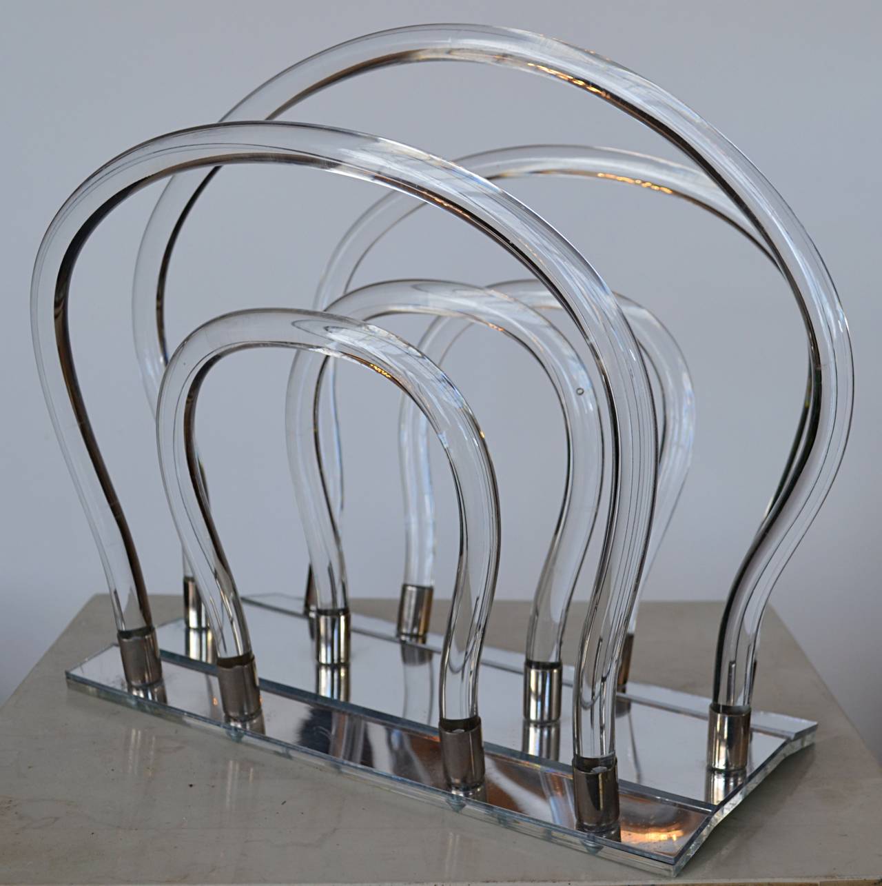 A classic Thorpe design executed in bent acrylic rods with chrome fasteners attached to mirrored base.