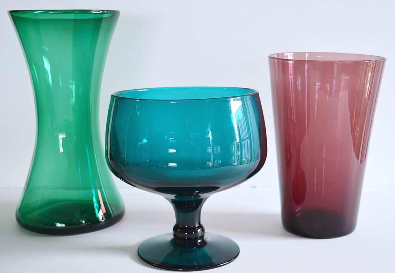 A collection of blown glass vase forms by the Blenko Glass Company. Corseted green vase 12