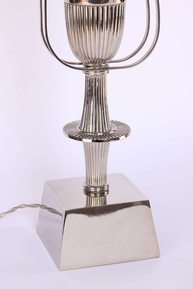 Elegant Tommi Parzinger neoclassical urn-shaped, silver plated table lamp for Lightolier's Heritage Silver collection. This lamp is in beautiful condition with minor signs of age. A single socket inside the urn provides up lighting, USA, circa