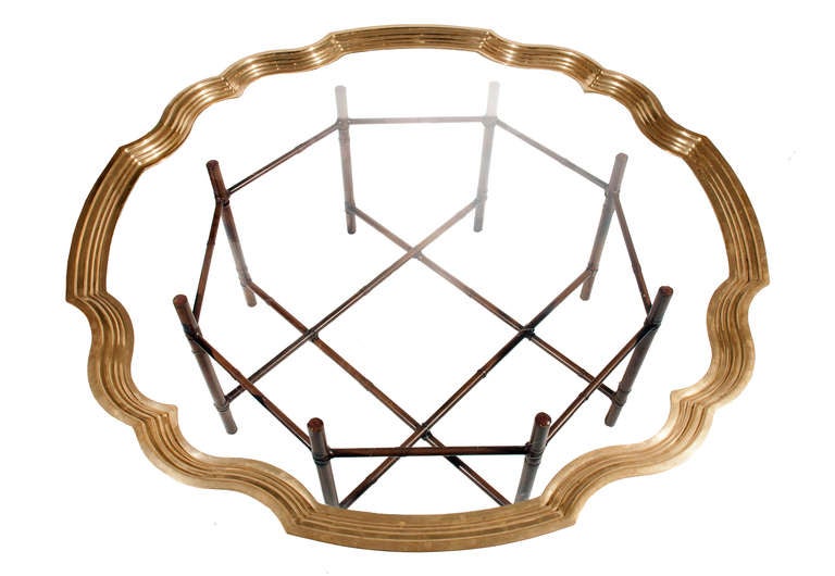 Substantial Baker coffee table with a removable solid brass and glass tray top that rests on an eight-leg, faux-bamboo metal base.