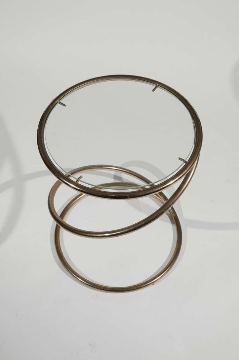 Coiled brass form with inset glass top. This item is located in our Chicago warehouse, pending shipment to Brooklyn.