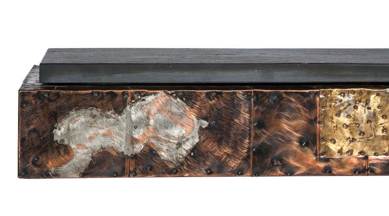 Stunning 1970s Paul Evans for Directional patchwork console and mirror. Each piece is clad in nailed-on patinated copper, brass and pewter panels arranged in a patchwork pattern. The wall-mounted console features a thick, natural cleft slate top and