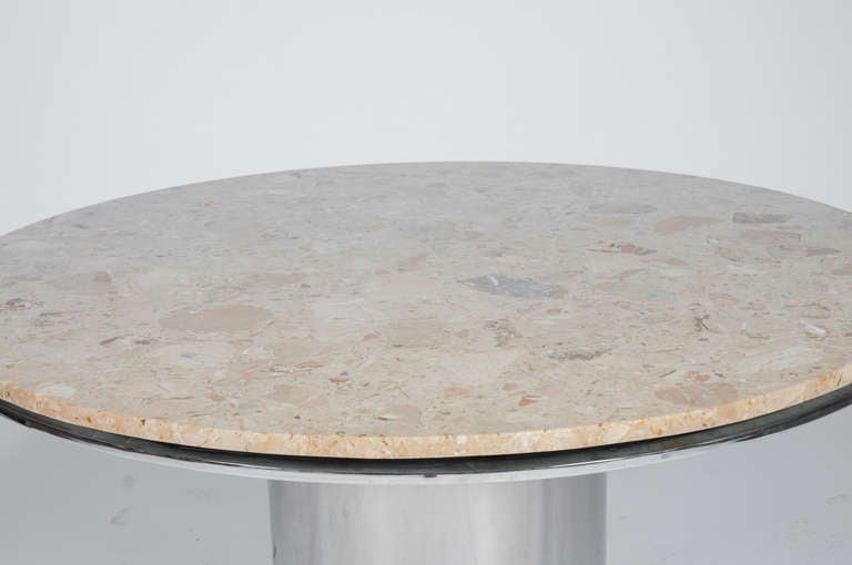 Gorgeous tan limestone top rests on a thick circular polished stainless steel pedestal base and apron. Interesting reveal between top and apron. Please inquire if this item is located in Brooklyn or our Chicago warehouse.