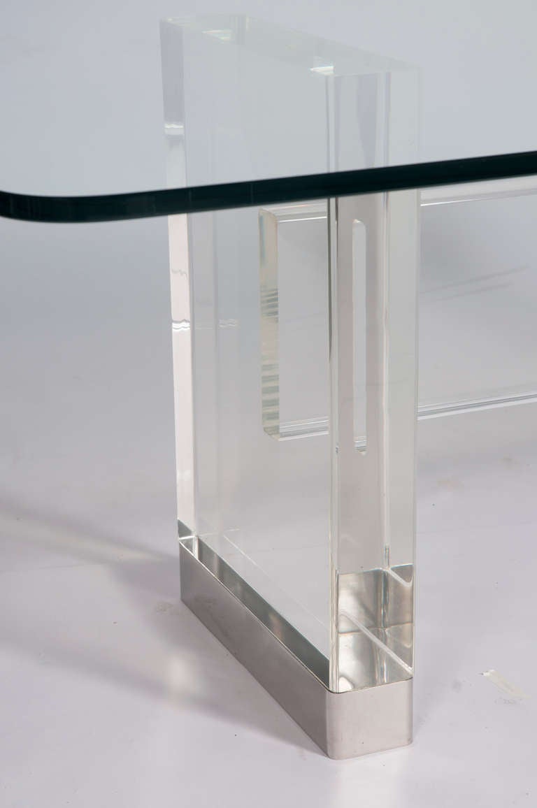 High-quality, 4-inch-thick lucite slabs form the legs; chrome-wrapped feet make it float weightlessly. Shiny, elegant, substantial—this is a truly special table. Signed Gary Strutin on base.