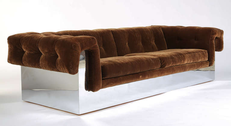 Super chic and very comfortable Milo Baughman sofa in original 1970s brown velvet upholstery. Chrome wraps entire base and forms support for the button-tufted arms and back. Elegant from every angle—his best sofa design. Thayer Coggin tag. This item
