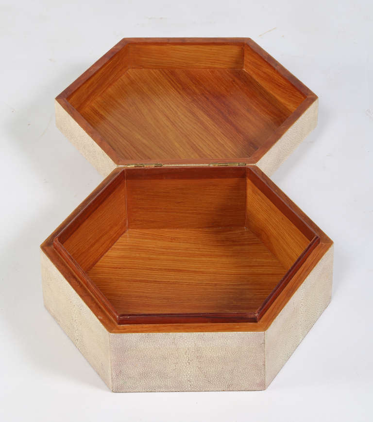 A hexagonal wood box wrapped in a beautiful dyed shagreen. The six sides of the top come to a point capped with a small piece of bone. A lovely and luxurious decorative piece. Maitland-Smith tag on bottom. This item is at the 1stdibs Gallery at the