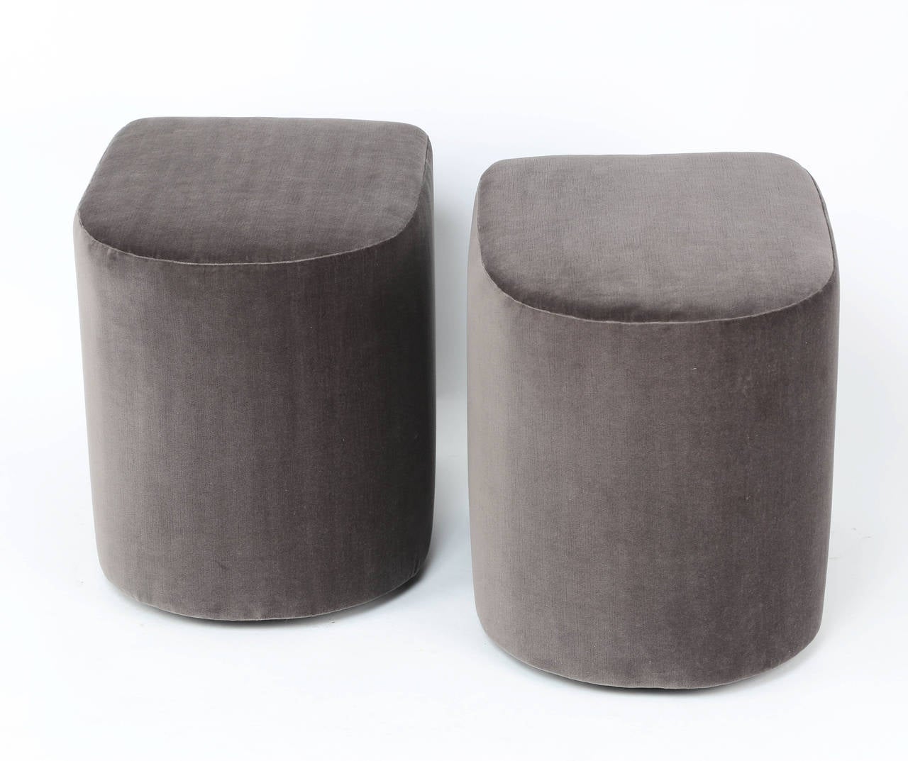 Unusual, rounded 1980s stools on recessed casters. Newly reupholstered in smokey-gray cotton velvet. Signed "Milo Baughman" with original tags. Fabric swatch available. These stools are at the 1stdibs Gallery at the New York Design Center,