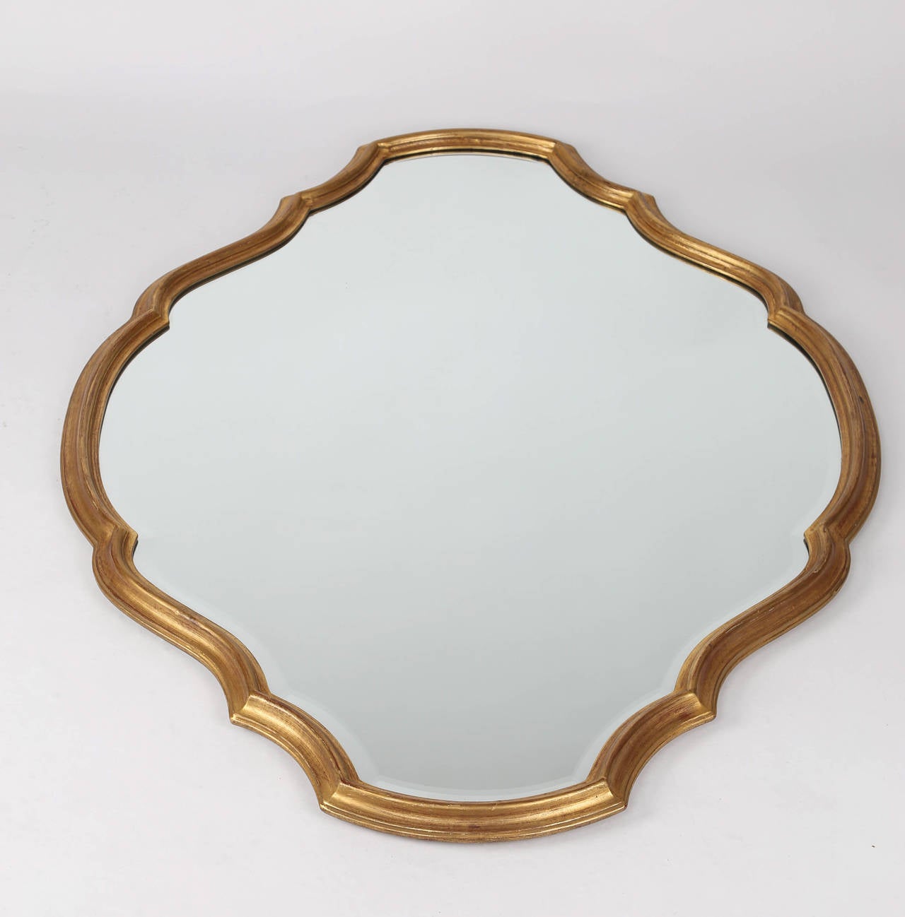 Large mirror in whimsical, symmetrical frame. The gilt-wood frame is 1.5