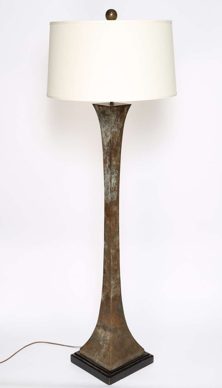 This lovely 1960s floor lamp features a sculptural bronze form over a black-painted mahogany base. The original ball finial tops an adjustable-height rod to support shades of various sizes. Very heavy and extremely well made. Gorgeous brown and