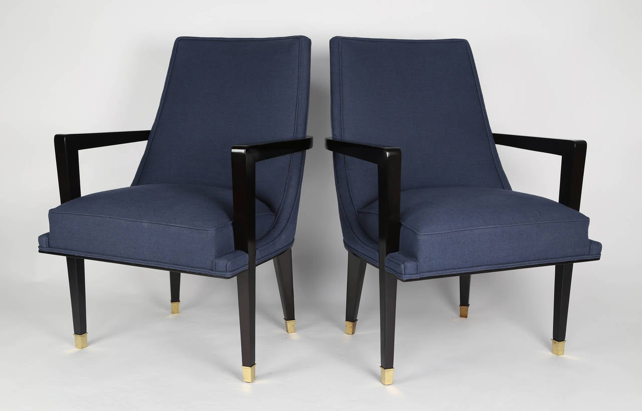 Superbly executed pair of 1950s chairs in Roberto and Mito Block's signature style with outstanding attention to detail. The tapered legs end in square brass caps. The integrated arms wraparound the back of the chair. The rear legs have an
