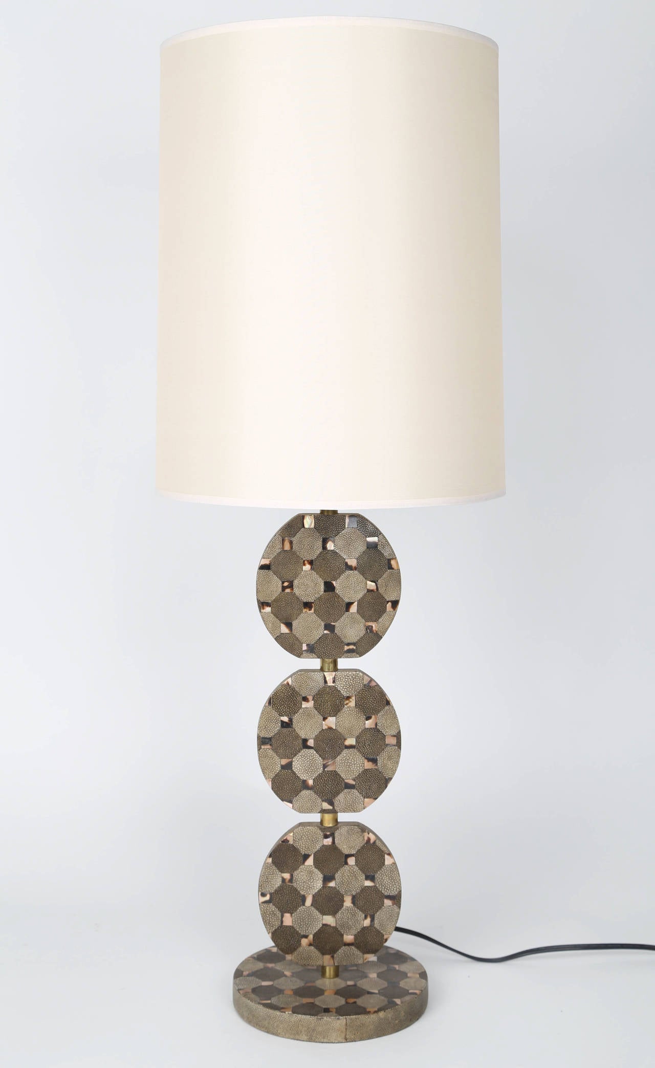 This understated but chic lamp features three rotating discs over a round base, with brass stem and finial. The discs are clad in octagonal shagreen tiles in two shades of grey, with square horn in-fill. Bottom is stamped 