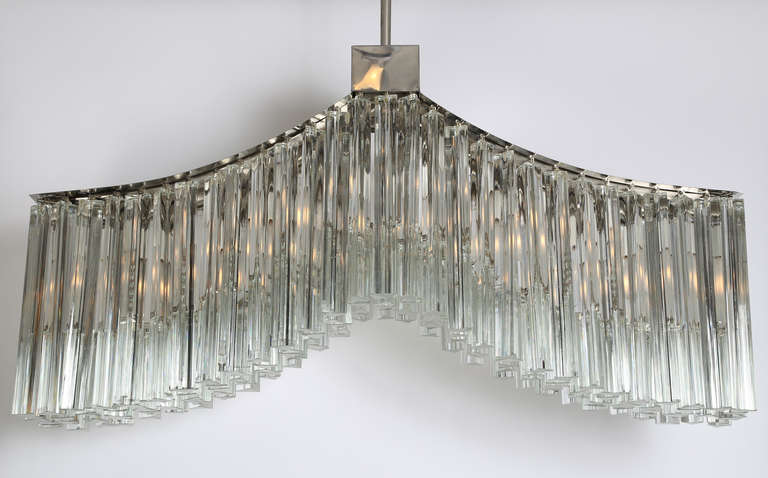 Gorgeous 1970s Camer crystal chandelier in the shape of a whale tail, the perfect shape for a rectangular dining table. Chrome frame, nine sockets, 174 crystals. To ceiling cap, 34