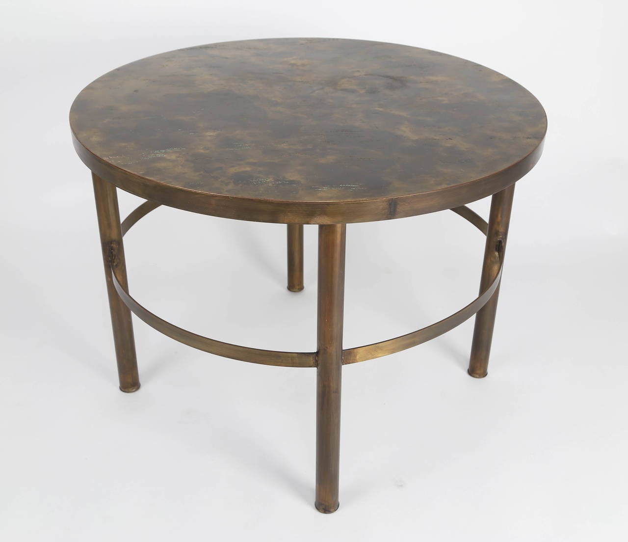 Gorgeous 1960s circular end or lamp table in patinated and etched bronze with tubular legs and banded stretchers, by father and son designers Philip and Kelvin Laverne. Etched signature on top and paper label on underside. 

See this item in our