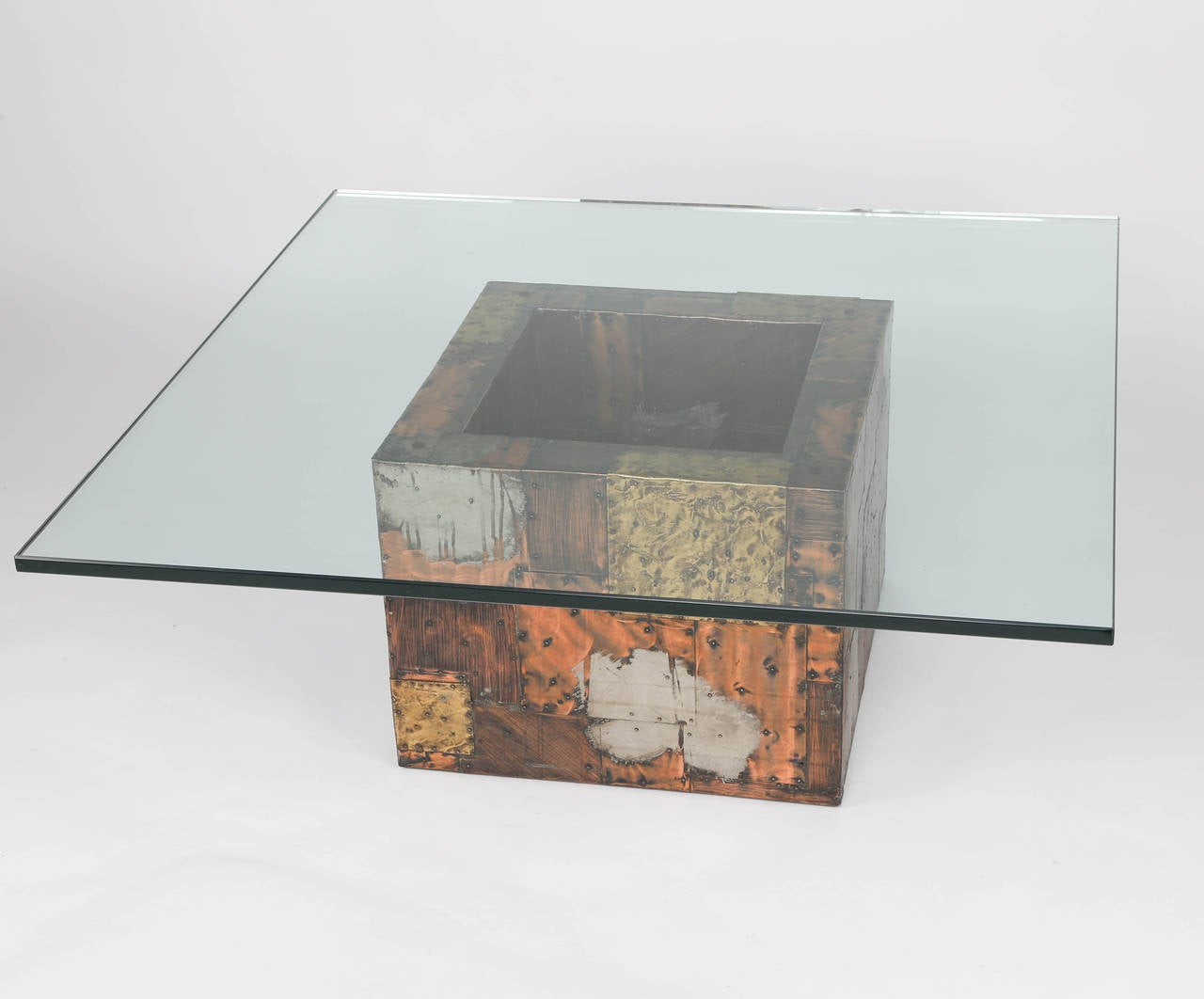 1970s Brutalist Paul Evans for Directional cocktail table clad in nailed-on panels of patinated copper, brass and pewter arranged in a patchwork pattern. New 3/4