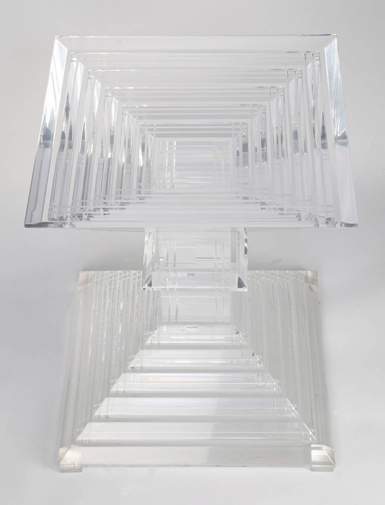 Gorgeous and heavy 1970s stacked acrylic side table in the form of two pyramids.  The multi-faceted layers of lucite reflect light beautifully. This item is at the 1stdibs Gallery at the New York Design Center, 200 Lexington Ave., 10th floor, New