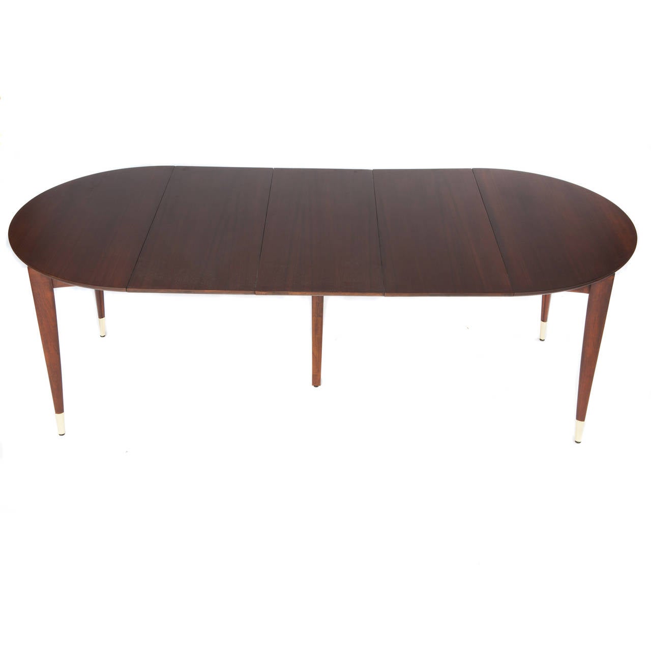 Round, expandable dining table in rich brown Italian walnut supported by tapered legs with brass-capped feet. The table is 40