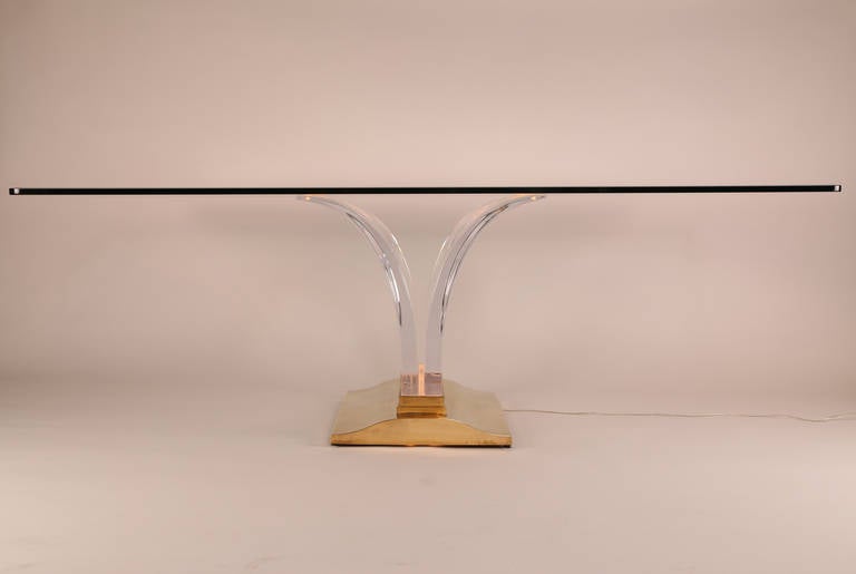 Leon Frost for lion in frost illuminated dining table. Heavy solid-brass base contains lighting elements and holds two large tapered and curved acrylic slabs supporting a 3/4 inch thick beveled glass top. Signed. This item is in our Brooklyn