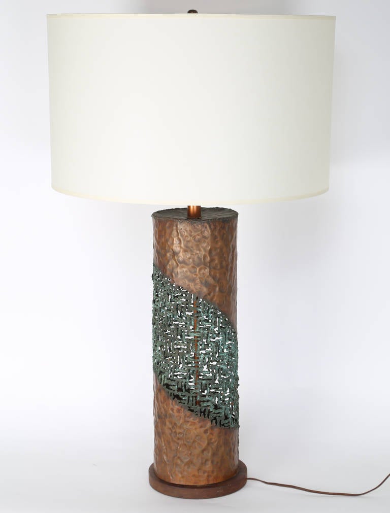 Stunning Marcello Fantoni Brutalist table lamp in hand-hammered copper with an intricate torch-cut lace pattern wrapping the cylinder, resting on a solid walnut base. Impressed signature in copper, 