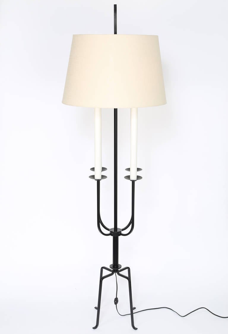 Elegant 1950s painted wrought iron candelabra floor lamp by Tommi Parzinger. Four Edison sockets underneath a tapered drum shade attached with a long square finial. 

See this item in the 1stdibs Gallery at the New York Design Center, 200 Lexington
