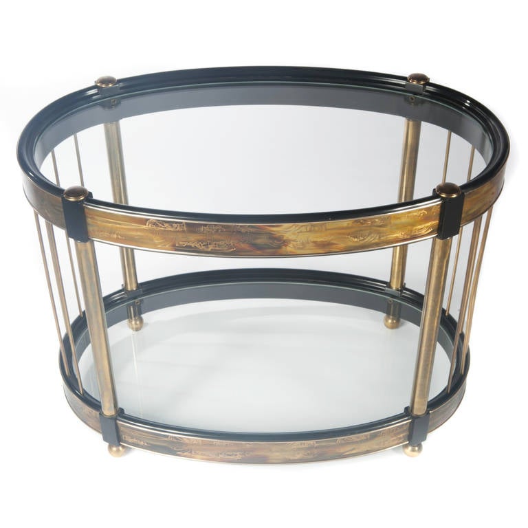 Bernard Rohne for Mastercraft oval-shaped, two-tier side table in warm burnished brass with etched brass bands around upper and lower shelves. Ball-shaped feet. This item is in our Brooklyn showroom.