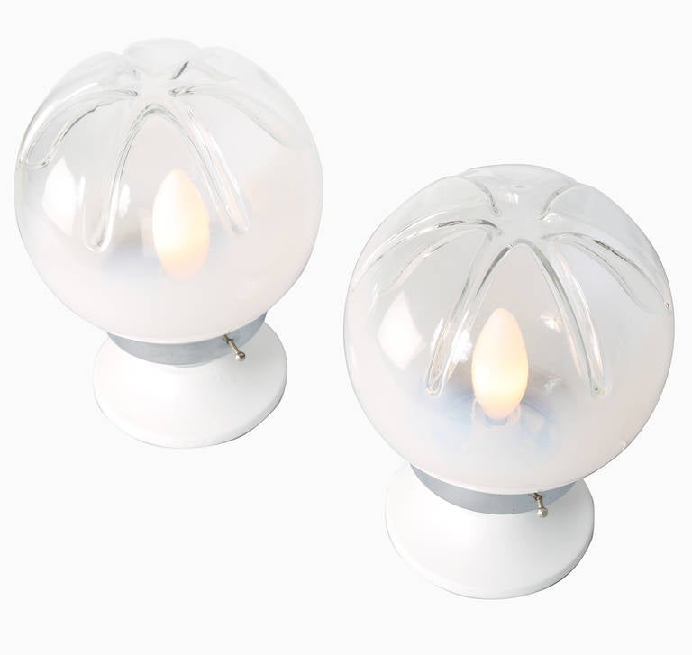 Diminutive Murano glass accent lamps feature Mazzega's signature impressed pattern on top. Glass fades from white to clear. Chrome shade holders, white painted wood bases. 

