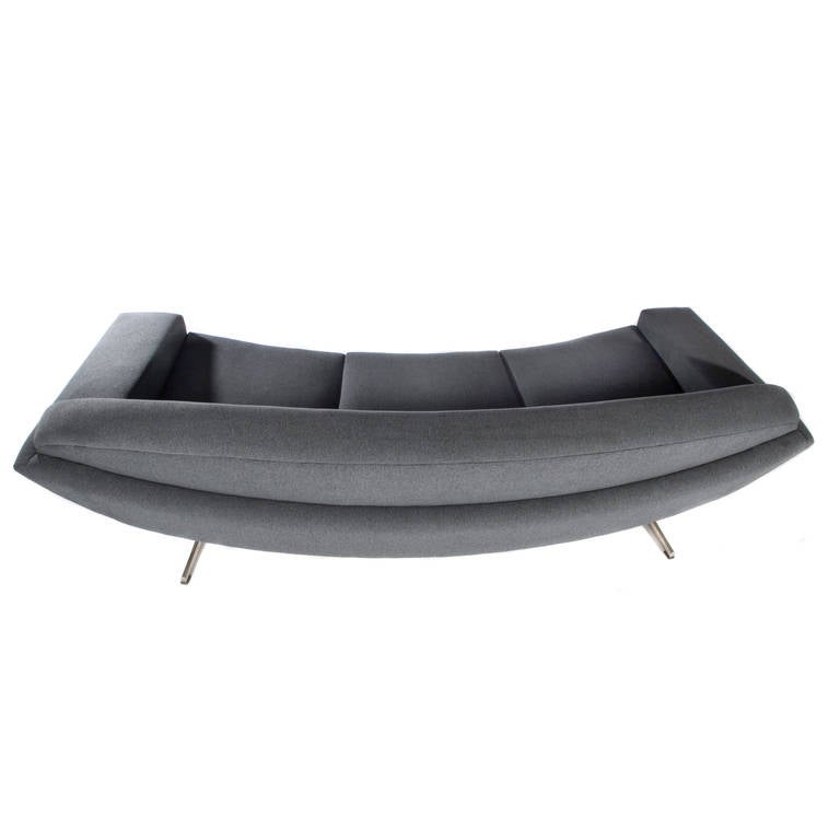 Futuristic sofa from Johannes Andersen's Capri line, designed in the late 1950s. Curved, large and dramatic, a sculptural sofa from every angle. Newly reupholstered in gray wool. Also see our coffee table and our pair of large swivel chairs from the