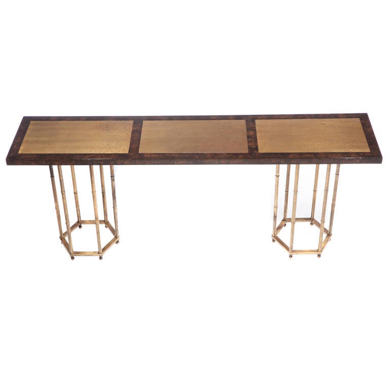 Console table with rich, dark burled veneer and three inset brass panels with decorative imprint. The base consists of two six-sided, faux-bamboo supports. This item is in our Brooklyn showroom.