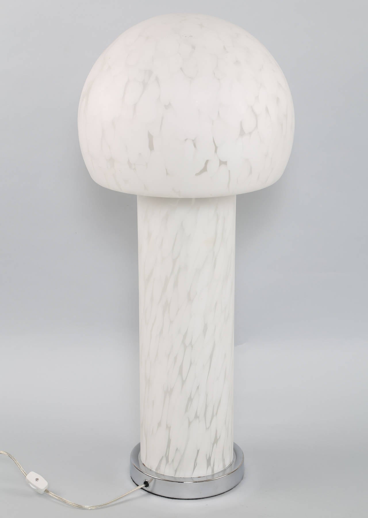 Tall and striking Murano table lamp with clear and white handblown mottled-glass, circa 1970s. Globe shade over internally lit columnar body on a round chrome base. Base is 7-1/2