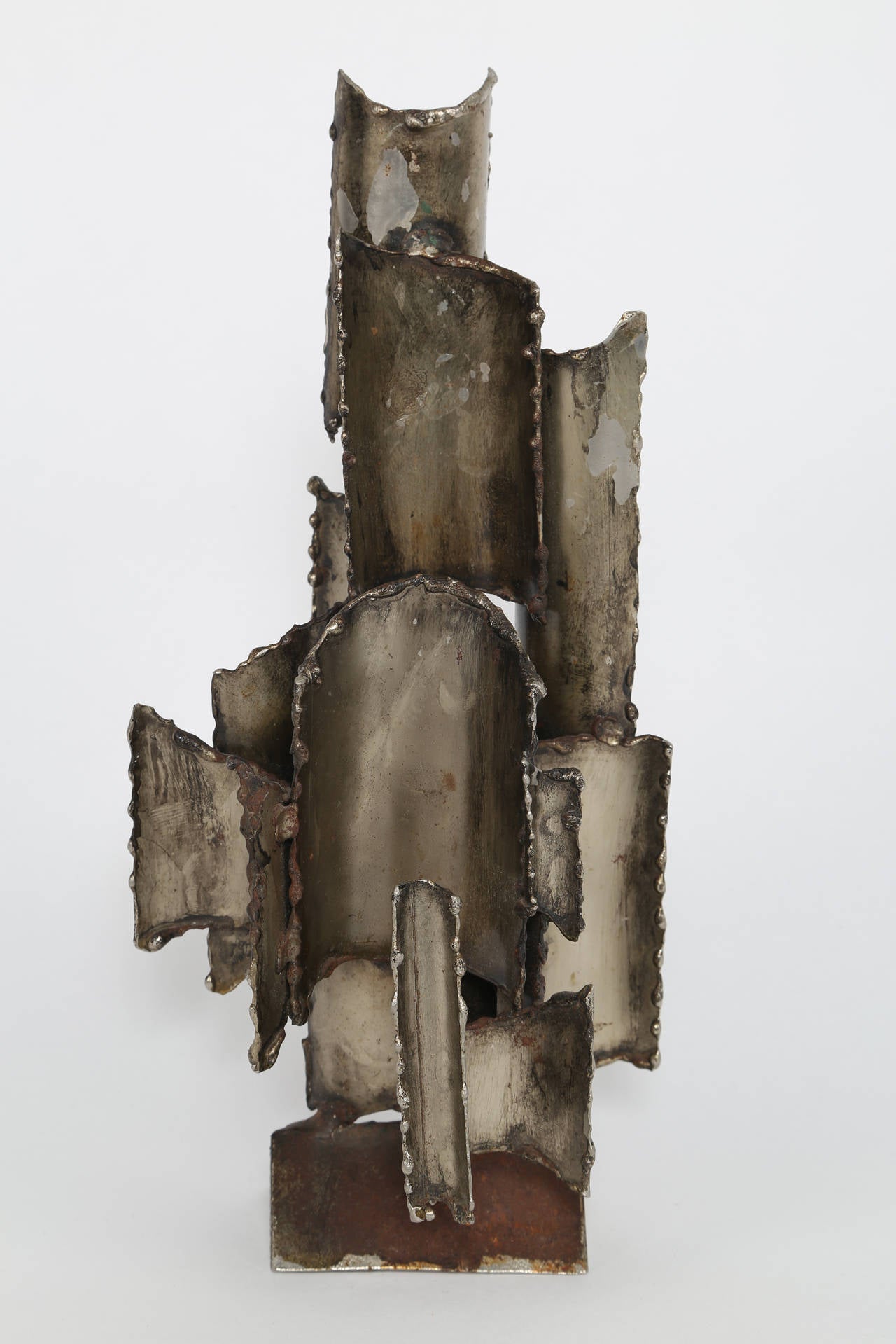 Abstract sculpture of curved torch-cut steel elements welded onto a triangular base. Signed Fantoni Firenze Italy. 




