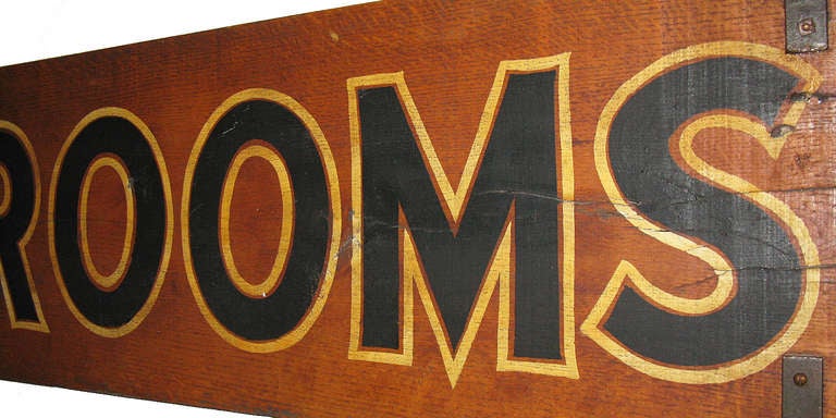 This large, double-sided sign advertising rooms with private bath came from a lodge in Baraboo, Wisconsin. It has a natural wood background with black lettering outlined in gold. It retains its sturdy old iron hinges and hooks. Its size, condition