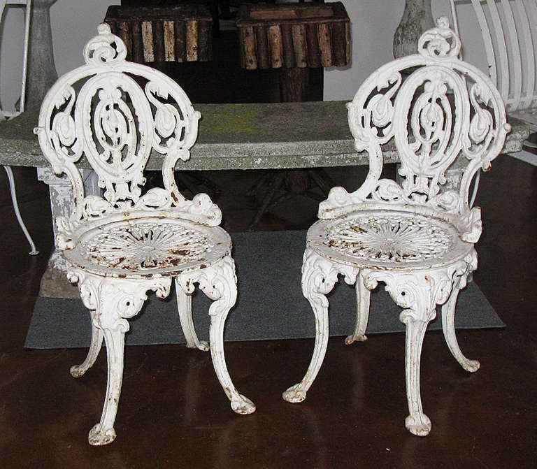 These two diminutive, heavy cast iron chairs are garden accents that also make convenient perches while stopping to smell the roses. The quality of these ornate period castings is excellent.