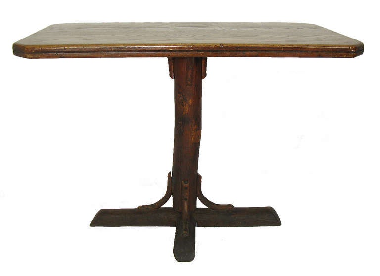 This table has a hickory pole pedestal base and a solid oak top.Â It is an uncommon form and size that makes a convenient wall, hallway, or sofa table, or it can be used as a breakfast table with a chair on each end.