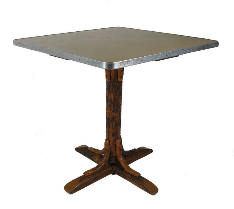 Each is a small square dining table with a hickory pole pedestal base and a faux bamboo grain Formica top. We have five of these tables for sale - they were a custom order for a corporate clubhouse in Wisconsin. They are in remarkably good