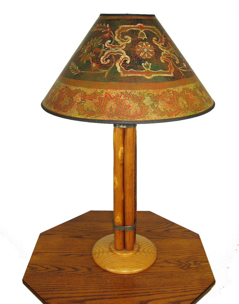 This Old Hickory table lamp is a rare find. The shaft is four hickory poles that are bundled with metal strapping, and the round base is oak. It takes two bulbs, each having its own pull chain. The lamp has been rewired and has a new 20