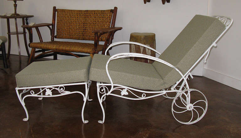 The frame of the chaise and ottoman are wrought iron in an ivy vine pattern.  The chaise rolls easily on its wheels, and the seat back is adjustable to various positions. The ottoman slopes comfortably downward as a leg rest. The replacement