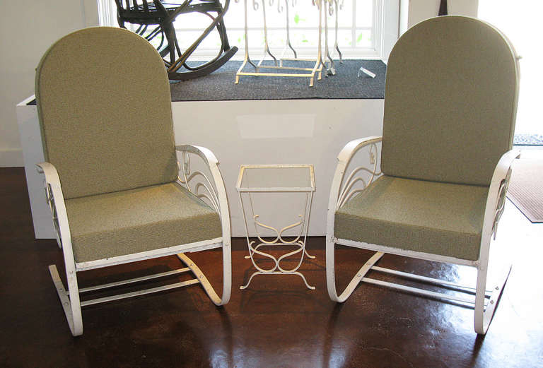 These classic wrought iron patio spring chairs have curved legs shaped so that the chair comfortably bounces and rocks. They have replacement cushions covered in Sunbrella. A small wrought iron side table (12