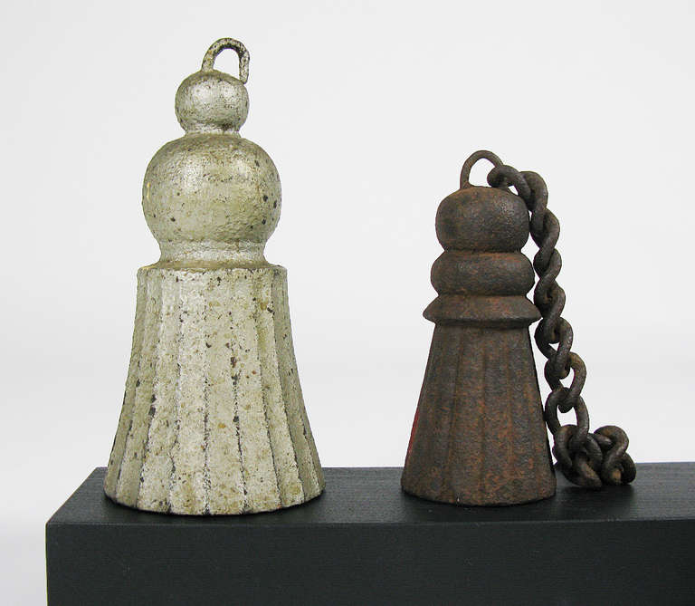 These decorative cast iron gate weights in a variety of shapes and sizes were assembled by a collector. The shapes mimic fringed and braided curtain tassels. Once used to counter balance a gate upon opening, they are now collected as sculptural