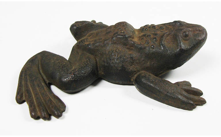 A heavy frog poised to leap serves as a doorstop, paper weight, desk or garden ornament.