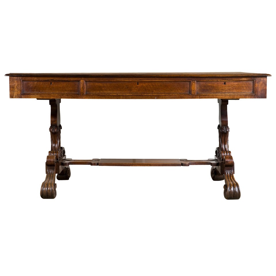 Oak Standard End Writing Table circa 1840 with Foliate Carving to the Ends and Feet and with Original Rexine Top For Sale