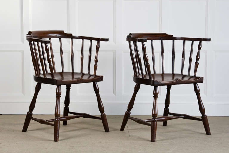 A pair of mid 18th century mahogany windsor armchairs