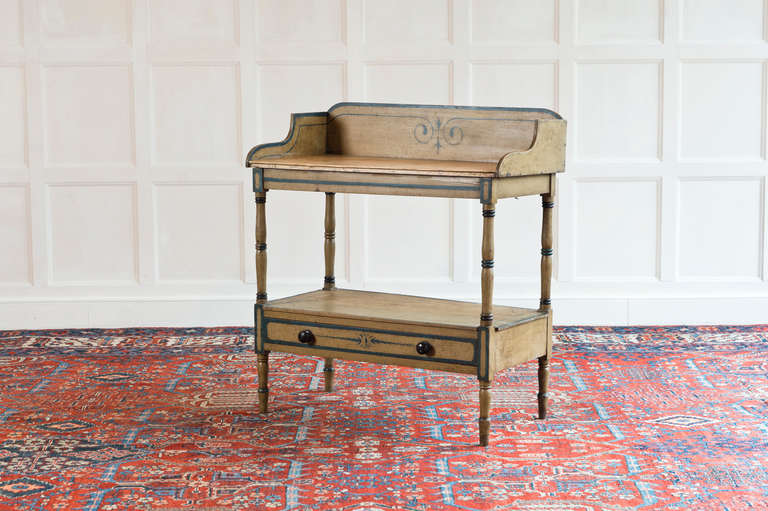 Painted washstand circa 1840. In its original painted finish. The marbled top is later and covers the washbowl hole