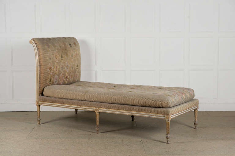 A George III parcel-gilt-white painted daybed, attributed to Ince and Mayhew.