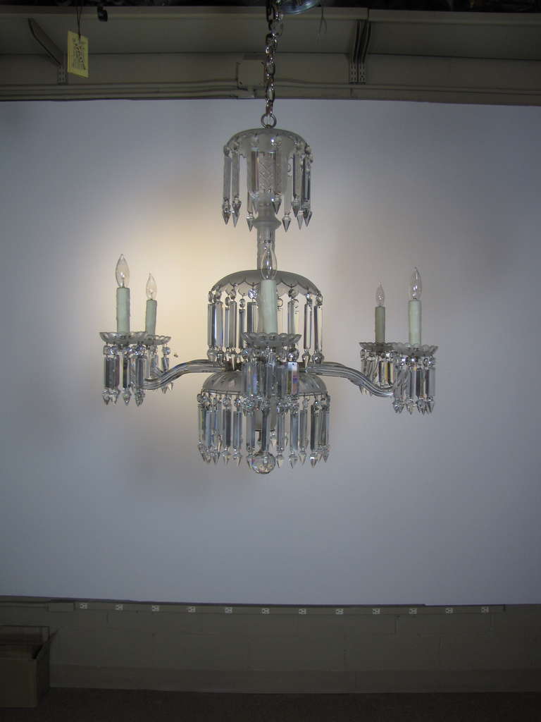 A six arm chandelier, originally gas.  An excellent example of 19th century American Victorian crystal.  Each arm is capped with scalloped bobeche hung with crystals and the center stem is adorned with three tiers of crystals. Stem pieces consist of