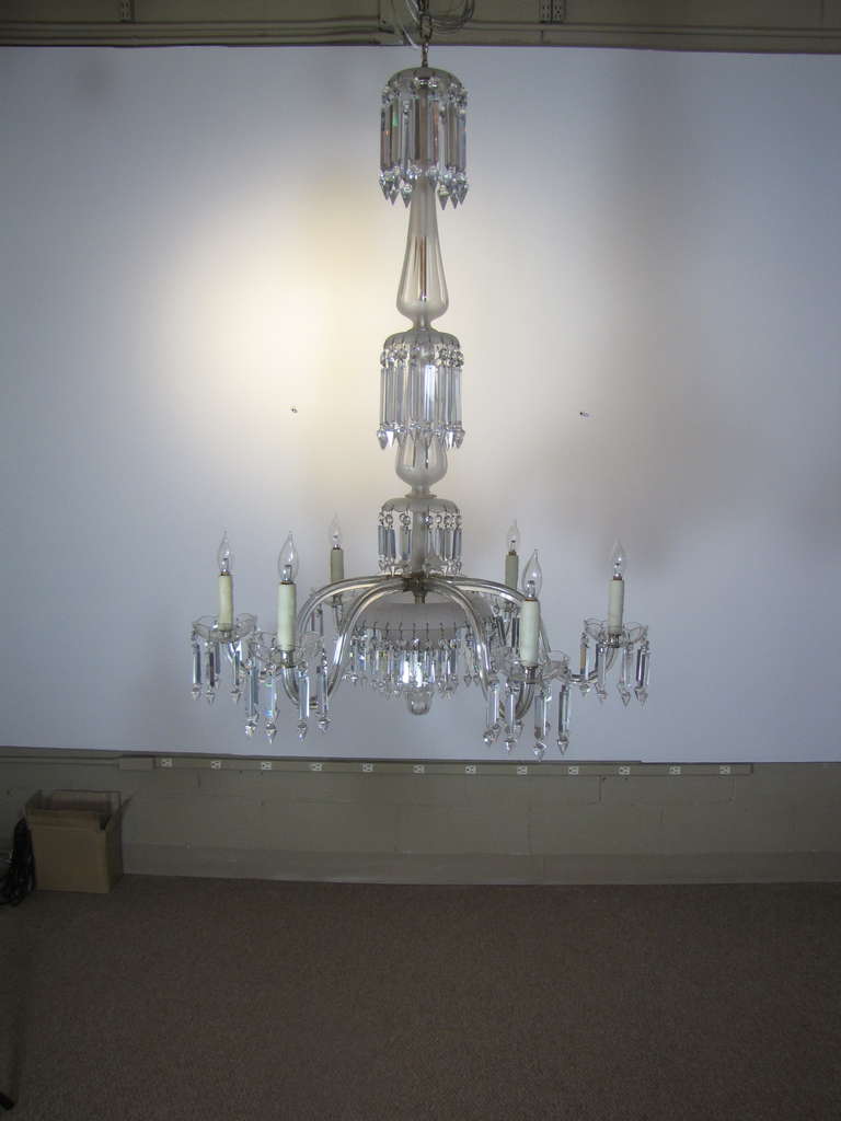 This is a 6 arm victorian frosted crystal chandelier.  It was made in the United States, and was originally made for gas.  The stem pieces are frosted and cut crystal, with four tiers of crystals.