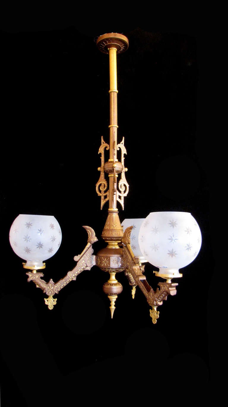 This is an Eastake Style Chandelier, which was originally gas.  The polychrome finish has been carefully restored through hand painting with mica paints.  Includes glass pictured, and can be shortened at buyer's request.