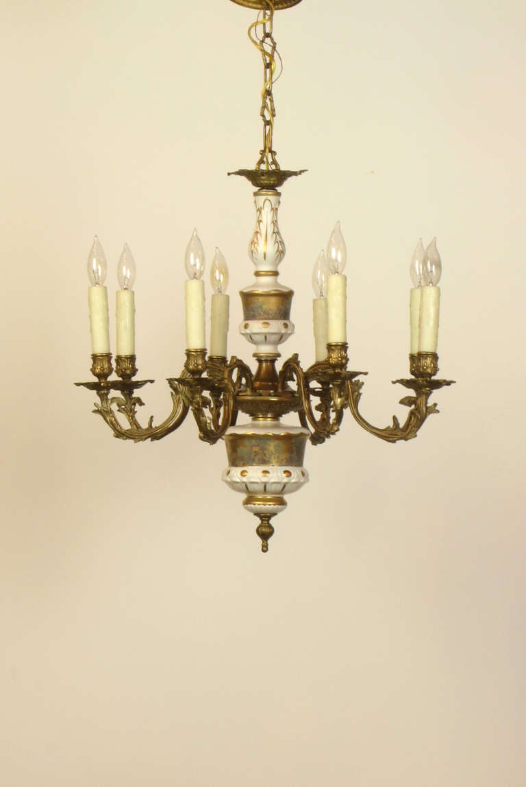 This is a French Chandelier Made with Limoges porcelain stem pieces depicting a pastoral scene, and bronze foliate arms.